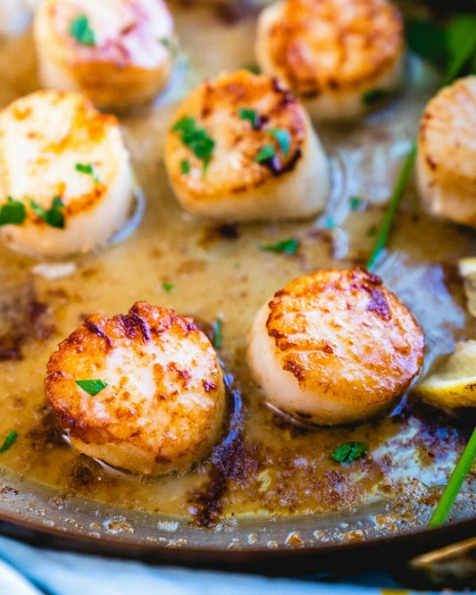 Pan seared scallops on a platter looking delicious