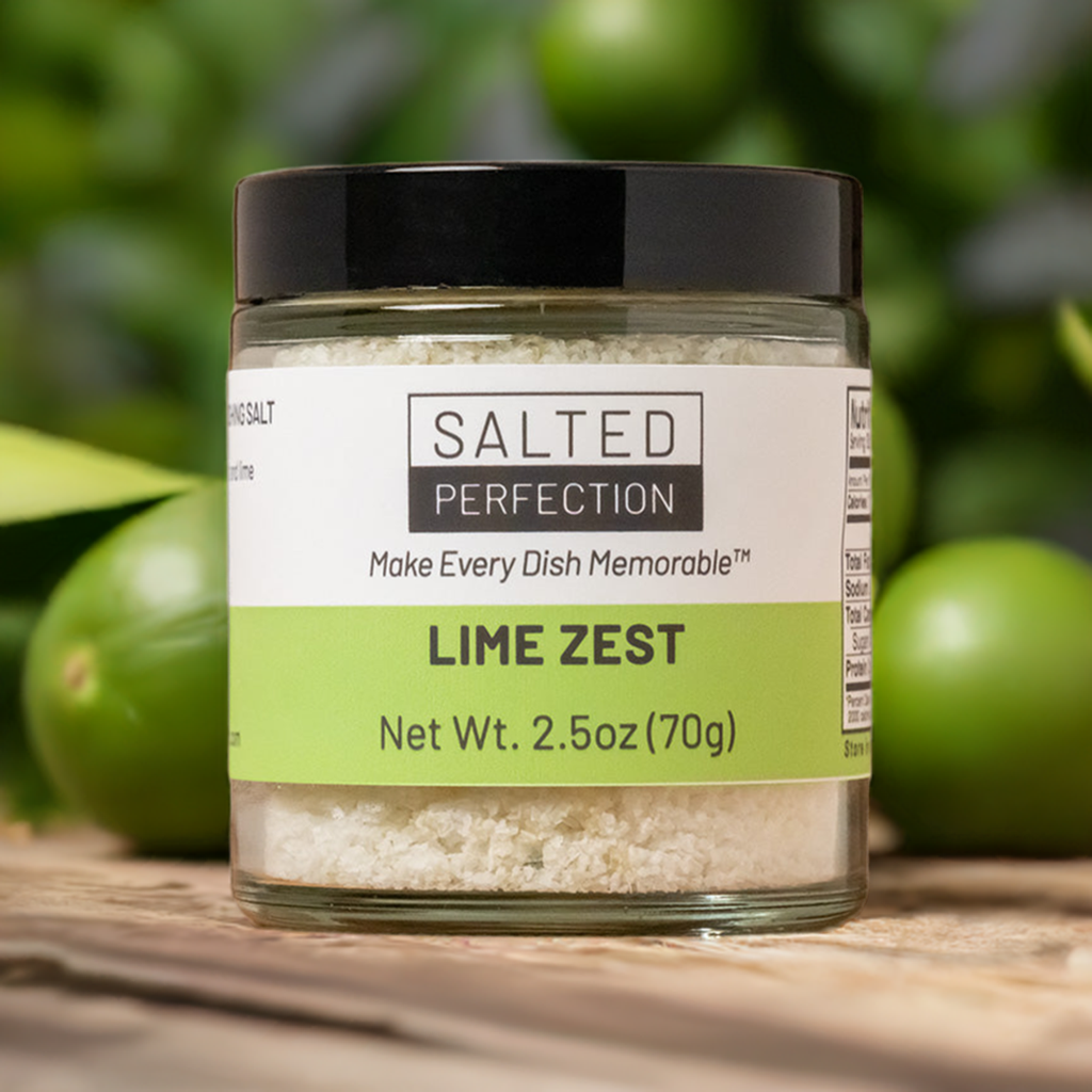 A jar of lime salt on a table in a lime grove surrounded by fresh limes